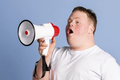 Boy with down syndrome using a megaphone to amplify his voice