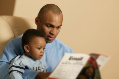 Father reading a book to his son